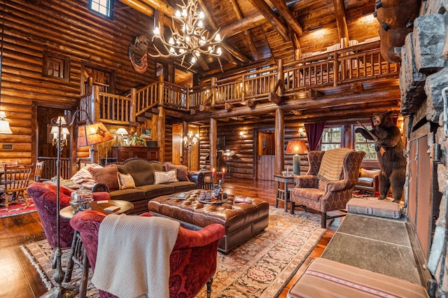 living area featuring rustic walls, a chandelier, a towering ceiling, hardwood / wood-style flooring, and wood ceiling