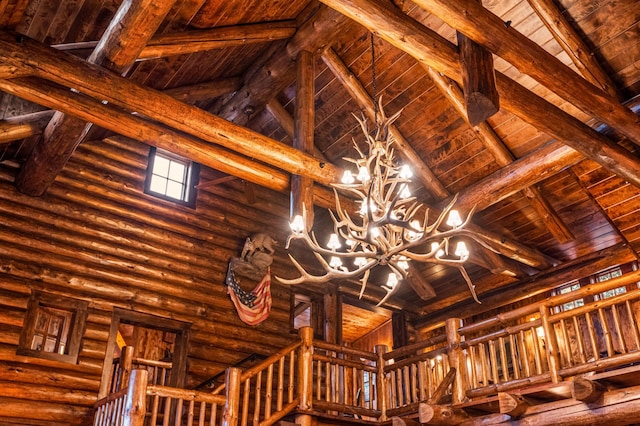 detailed view of wooden ceiling, a chandelier, and beam ceiling