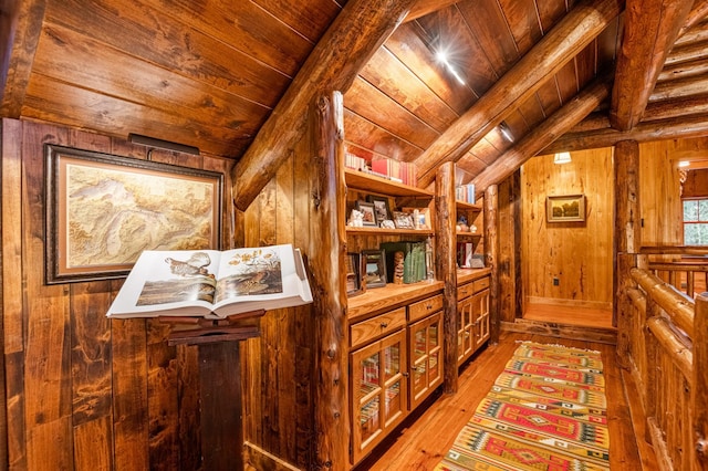 corridor featuring wood walls, wooden ceiling, and light wood-style floors