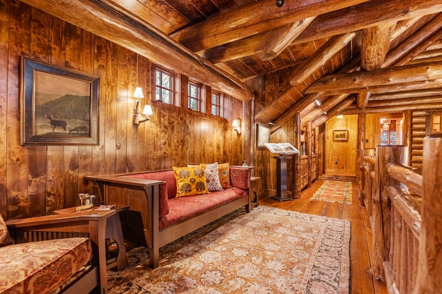 living area featuring wood-type flooring, wood ceiling, wood walls, and log walls