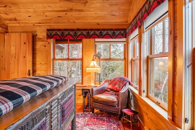 bedroom featuring wooden ceiling, wood finished floors, multiple windows, and wood walls
