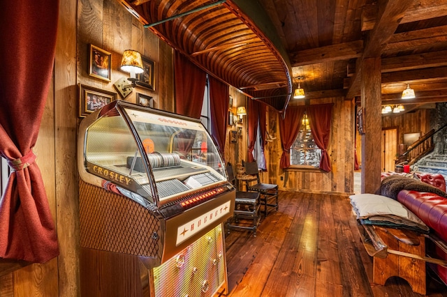 recreation room with hardwood / wood-style floors, wooden walls, beam ceiling, and wood ceiling