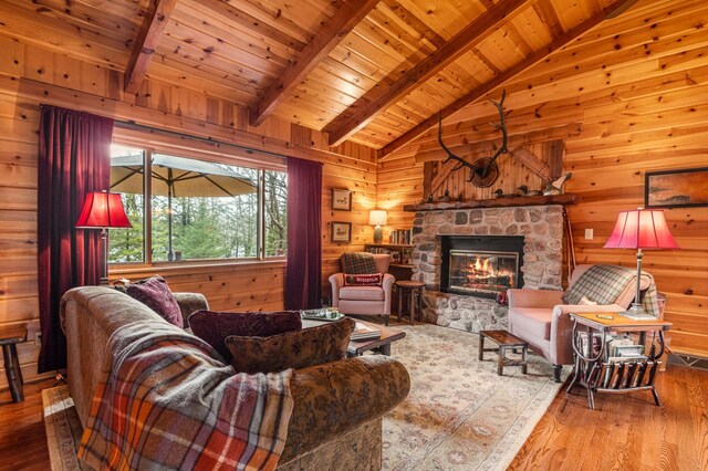 living room with hardwood / wood-style flooring, wooden ceiling, wooden walls, and a fireplace