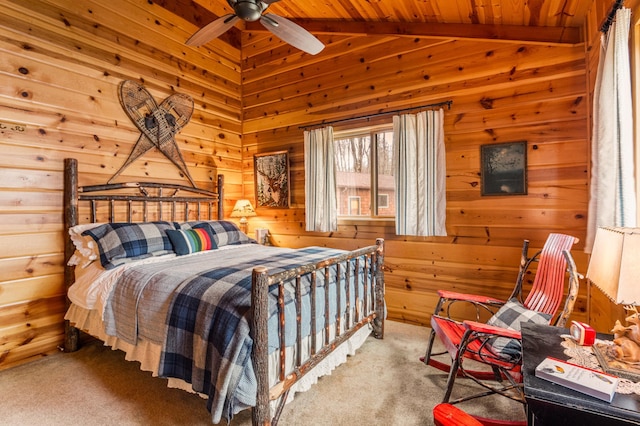 carpeted bedroom featuring wood walls, wooden ceiling, and ceiling fan