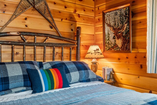 bedroom featuring wood walls