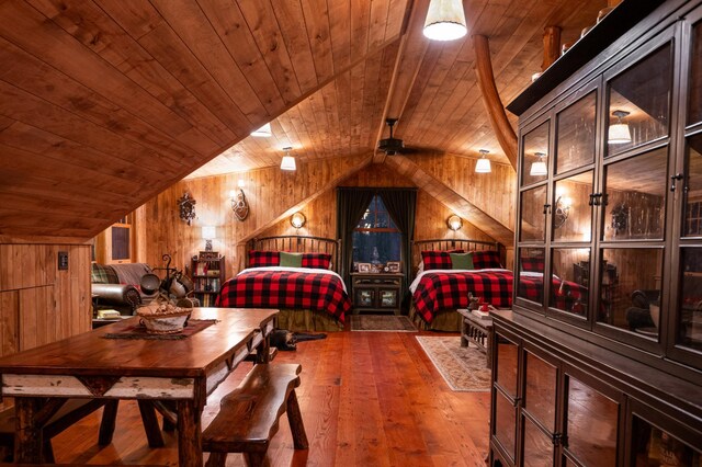 bedroom featuring wooden walls, wood ceiling, lofted ceiling, and hardwood / wood-style flooring