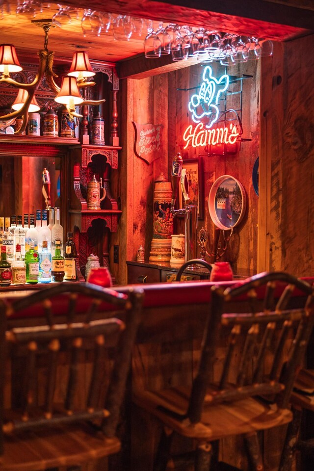 indoor dry bar featuring wooden walls