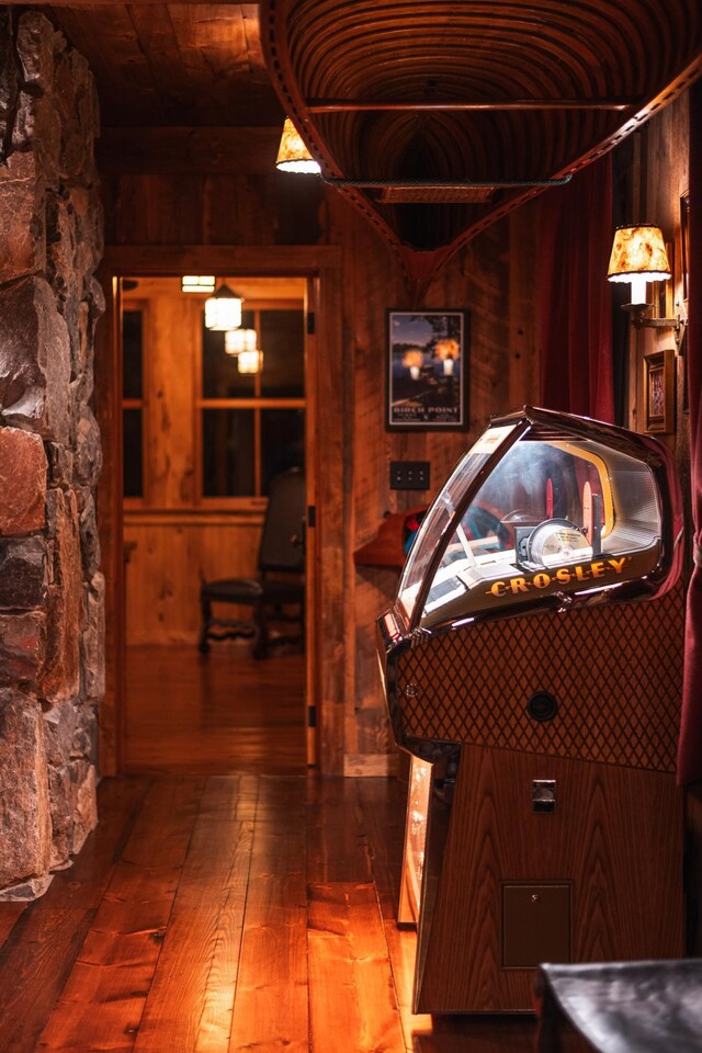 playroom featuring wood walls and hardwood / wood-style floors