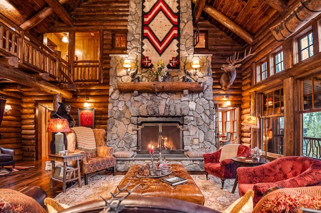 living room with high vaulted ceiling, a wood ceiling with exposed beams, hardwood / wood-style flooring, rustic walls, and a stone fireplace
