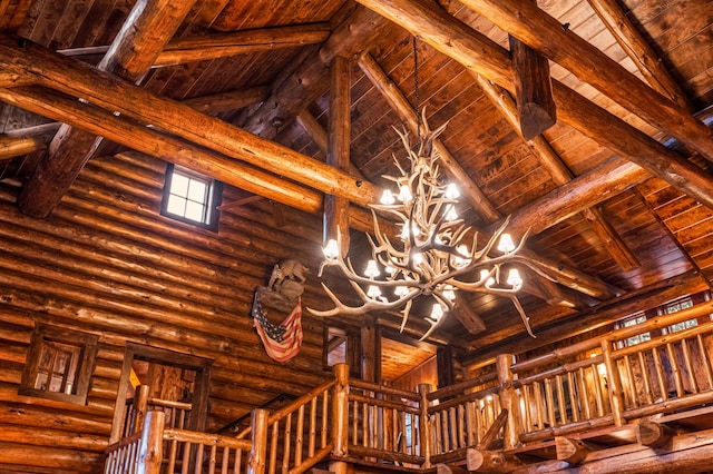 detailed view of a wood ceiling with exposed beams and a chandelier