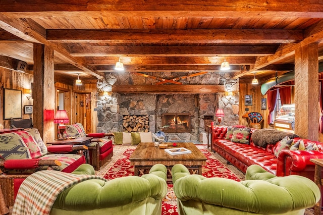 living room with a wood ceiling with exposed beams, a stone fireplace, and wood walls
