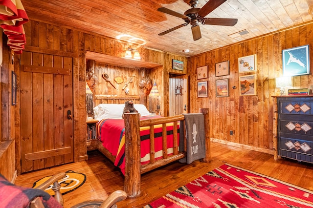 bedroom with wooden ceiling, wood walls, and wood-type flooring