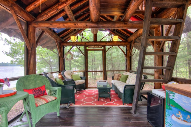 sunroom featuring an outdoor living space, vaulted ceiling, and a water view