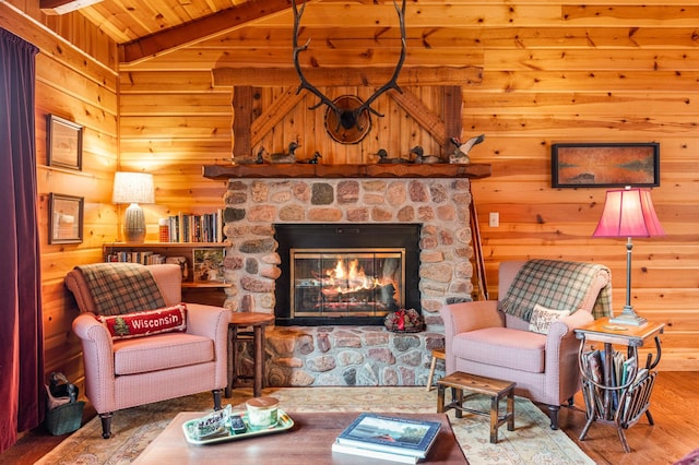 living room featuring wood finished floors, a fireplace, wood walls, and wooden ceiling
