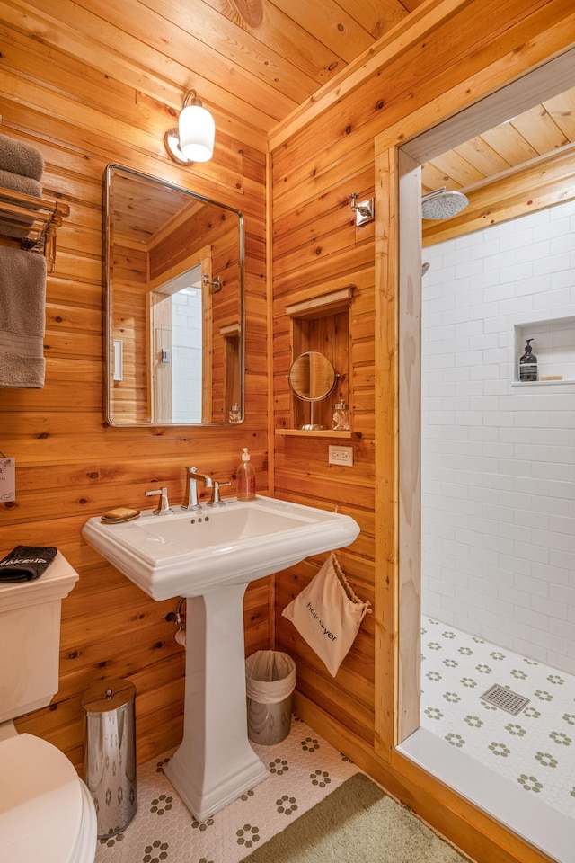 full bathroom featuring a shower stall, wooden ceiling, and wood walls