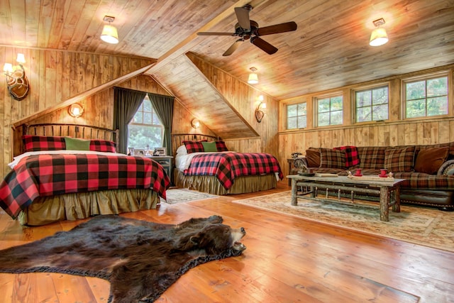 bedroom with wood walls, hardwood / wood-style flooring, wooden ceiling, and vaulted ceiling