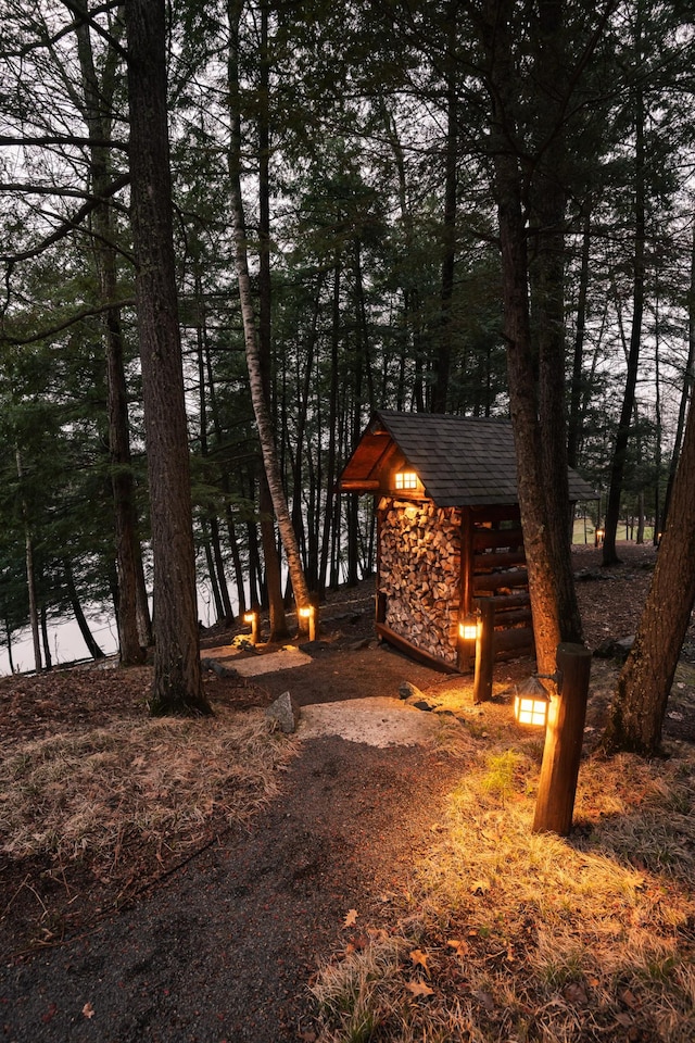 view of front of property with stone siding and an outdoor structure