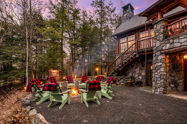 view of yard with stairs and an outdoor fire pit
