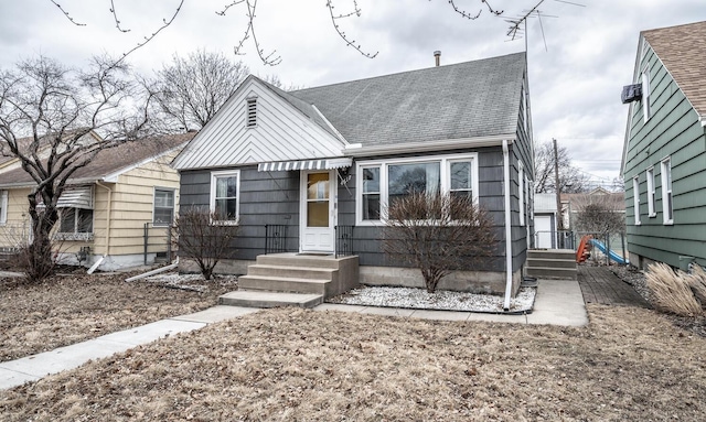 bungalow-style house with roof with shingles