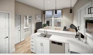 kitchen with a sink, white cabinetry, light countertops, light wood finished floors, and pendant lighting