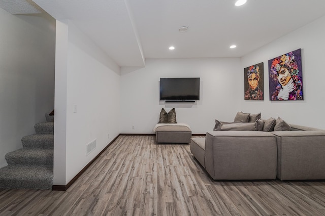 living room featuring recessed lighting, wood finished floors, visible vents, baseboards, and stairway