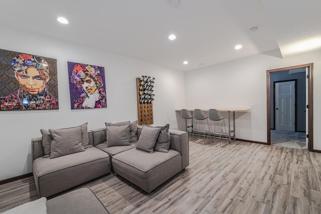 living room featuring recessed lighting, wood finished floors, and baseboards