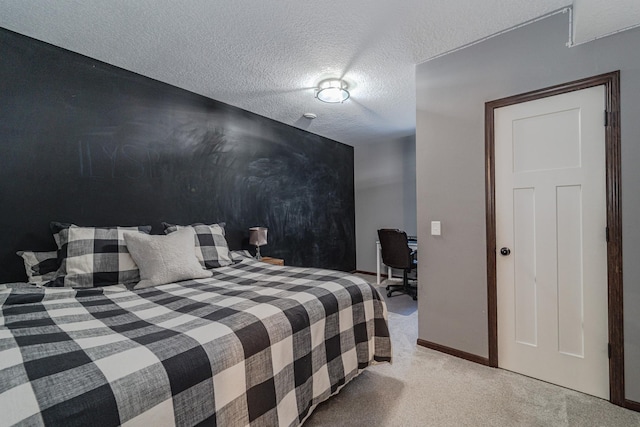 bedroom with a textured ceiling, baseboards, and light colored carpet