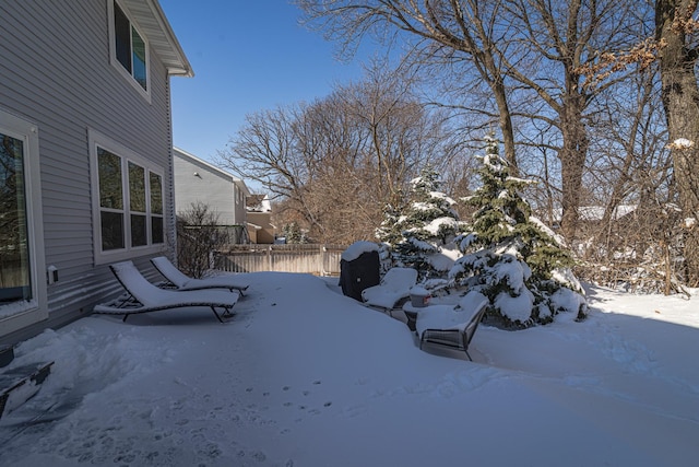 yard covered in snow with a garage