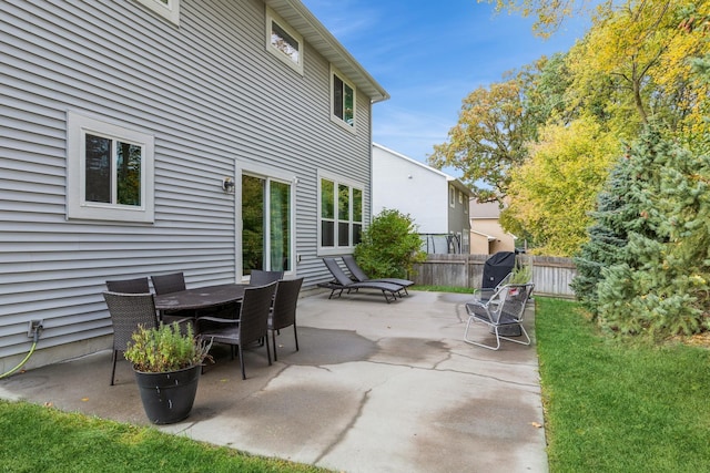 view of patio with fence and outdoor dining area