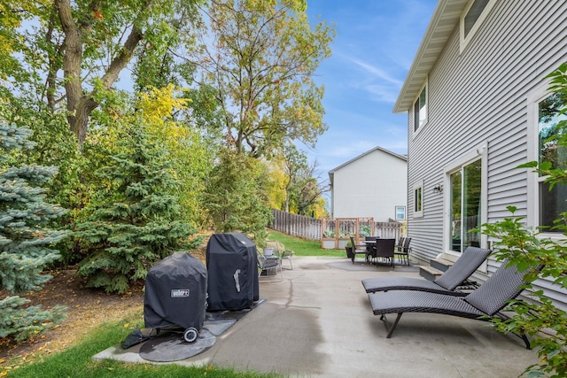 view of patio / terrace with outdoor dining space, fence, and area for grilling