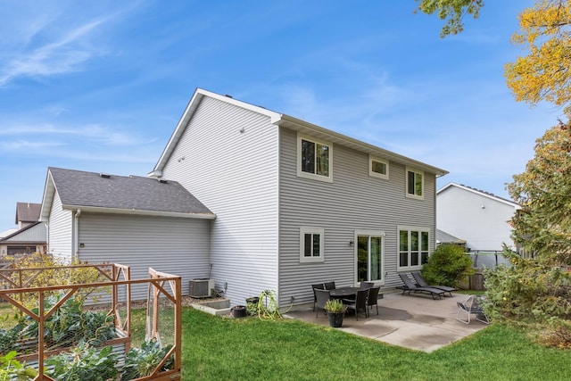 rear view of property with a lawn, a patio area, fence, and central air condition unit