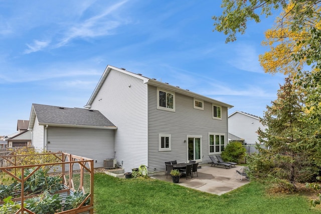 rear view of house featuring central AC unit, a patio area, fence, and a lawn