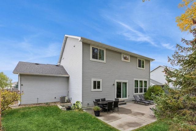 back of house featuring a patio area, a shingled roof, central AC, and a yard