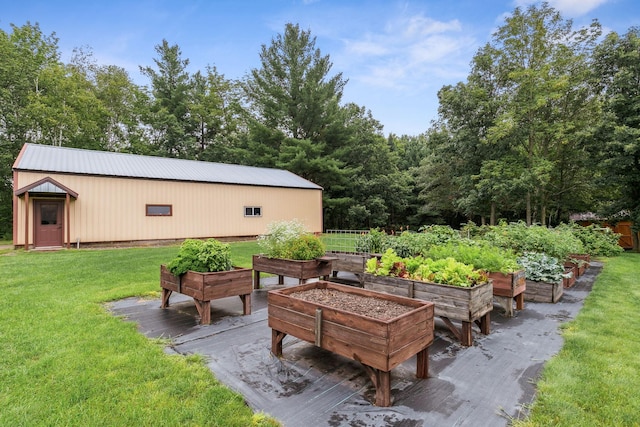 view of patio featuring an outbuilding, a garden, and an outdoor structure