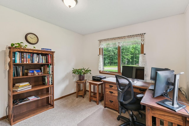 office space featuring carpet flooring, a textured ceiling, and baseboards