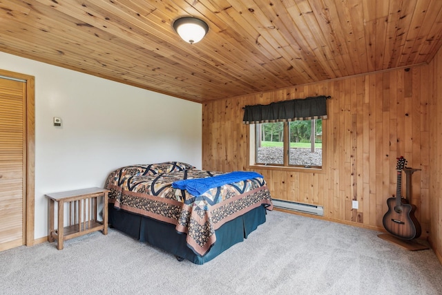 bedroom featuring wooden ceiling, baseboards, baseboard heating, and carpet flooring