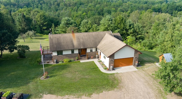 birds eye view of property with a forest view