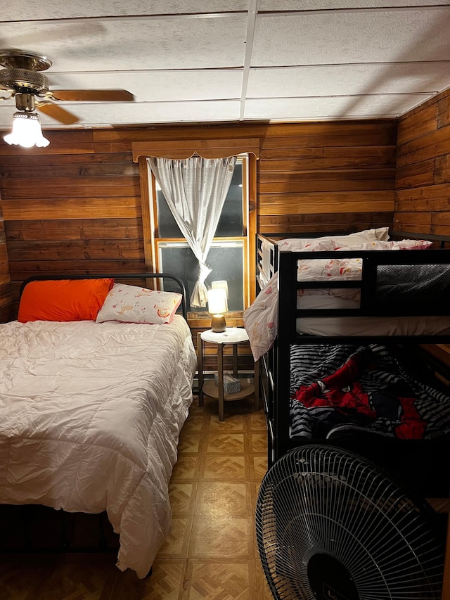 bedroom with wood walls and light floors