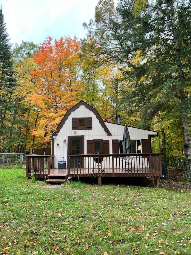 rear view of property with a deck and board and batten siding