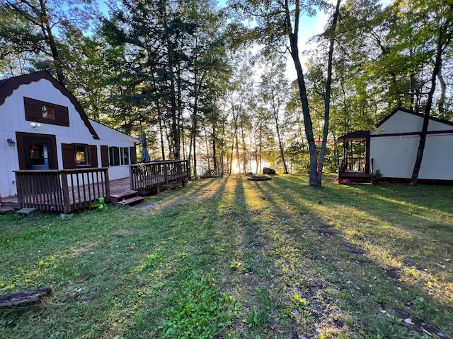 view of grassy yard featuring a wooden deck