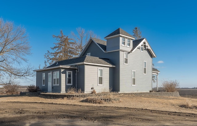 view of side of property with a shingled roof