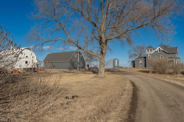 exterior space featuring a barn, driveway, and an outbuilding