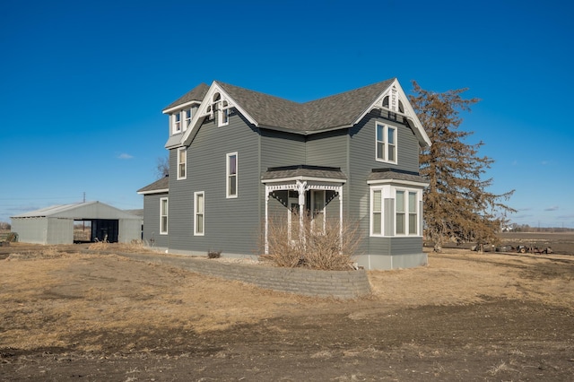 exterior space with roof with shingles