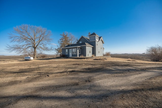 view of front of house with a rural view