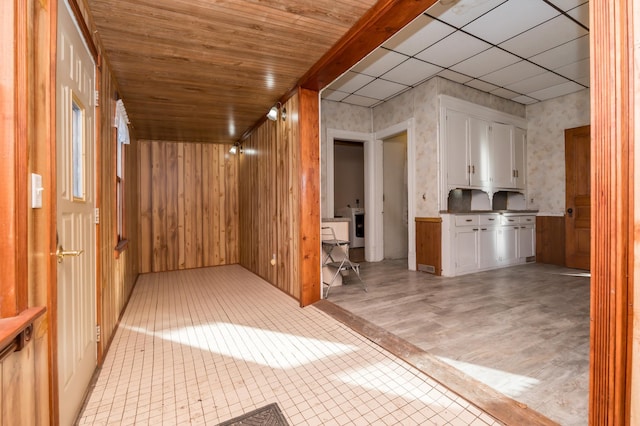 additional living space with wood walls and wood ceiling