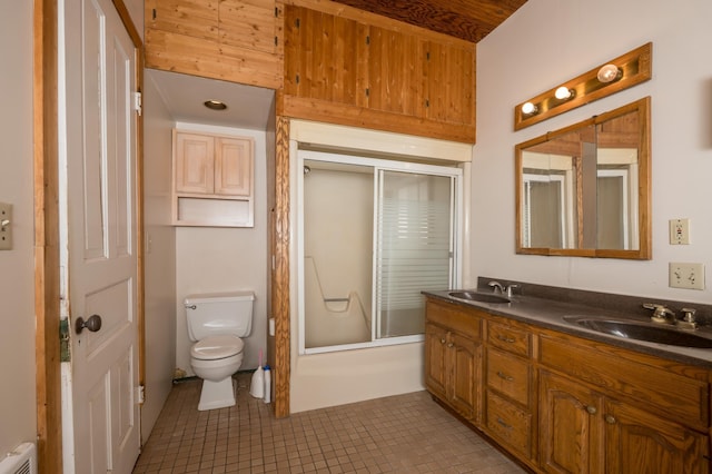 full bath featuring tile patterned flooring, a sink, toilet, and double vanity