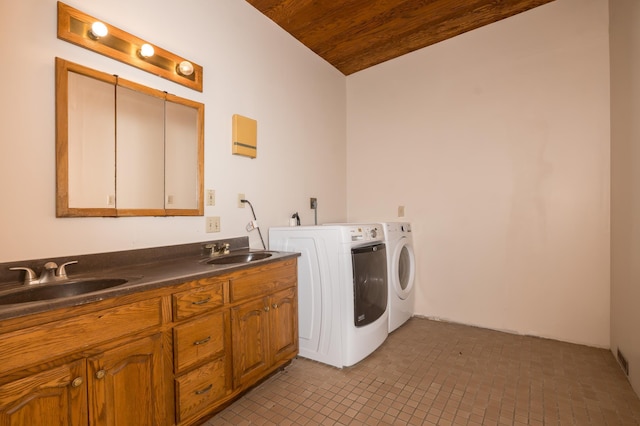 clothes washing area featuring separate washer and dryer, wooden ceiling, a sink, and cabinet space