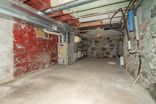 unfinished below grade area featuring heating unit and water heater