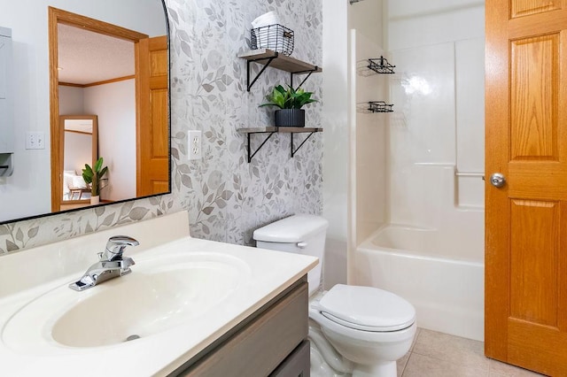 bathroom featuring toilet, vanity, tile patterned floors, wallpapered walls, and crown molding