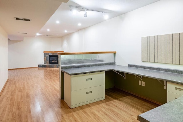 kitchen featuring a tile fireplace, visible vents, light wood-style flooring, and recessed lighting